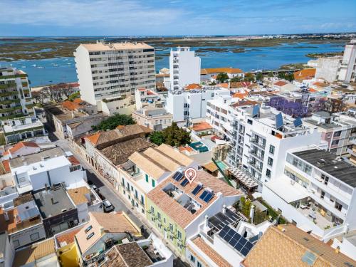 an aerial view of a city with buildings at Roots Apartments in Faro