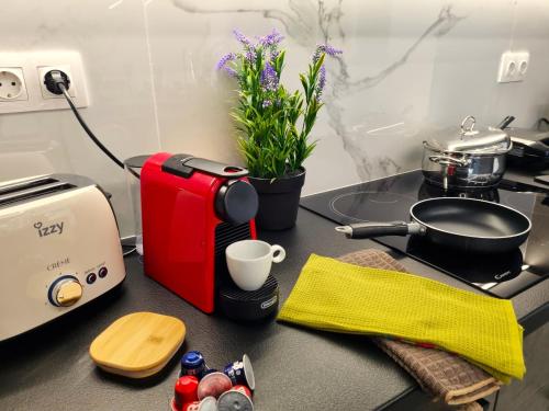 a kitchen counter with a toaster and a coffee maker at 10 Apartments & Suites Athens in Athens