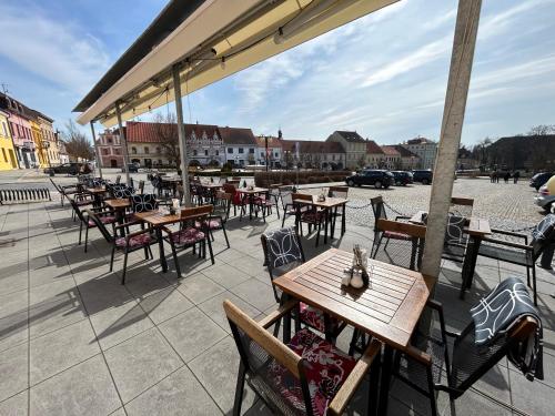 a group of tables and chairs on a patio at Hotel Panská in Bechyně