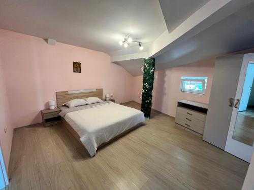 a bedroom with a large white bed and a window at Apartment Happy holiday Lazur in Burgas City