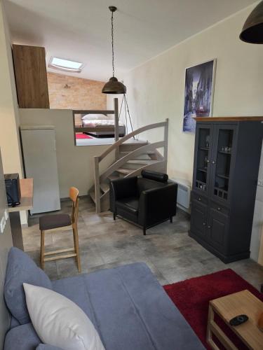 a living room with a staircase and a couch at Charmantes Studio Ferienhaus mit Garten & Netflix Nähe Spreewald in Heinersbrück
