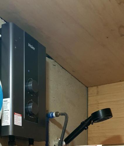 a black speaker on a wall with a microphone at Charming seaview chalet with AC, kitchen, downtown in Coron