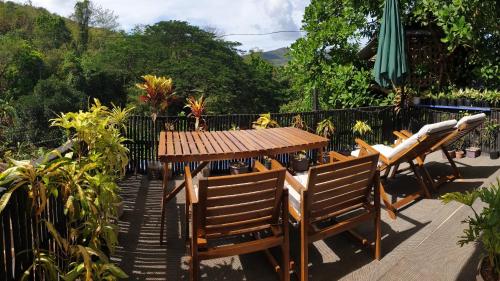 a wooden table and chairs sitting on a patio at Charming seaview chalet with AC, kitchen, downtown in Coron
