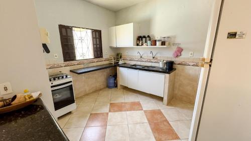 a kitchen with a sink and a stove at Casa de Praia - Praia Bela in Aquiraz