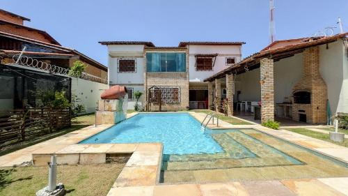 a swimming pool in the backyard of a house at Casa de Praia - Praia Bela in Aquiraz