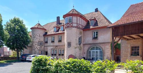 an old building with two towers on top of it at Ferienwohnung Schloss Fischbach in Ebern