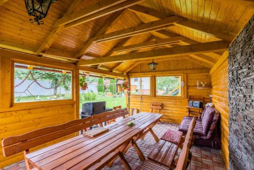 a large wooden room with a wooden table and chairs at Penzion JAS in Zuberec