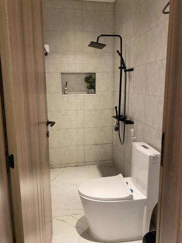 a bathroom with a white toilet and a shower at LAvenue RestHouse in Nizwa