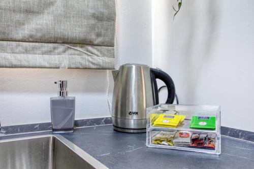 a kitchen counter with a tea kettle on a sink at Studio apartment 4 with kitchenette at the New Casa Vittoria by SF HOMES in Cospicua