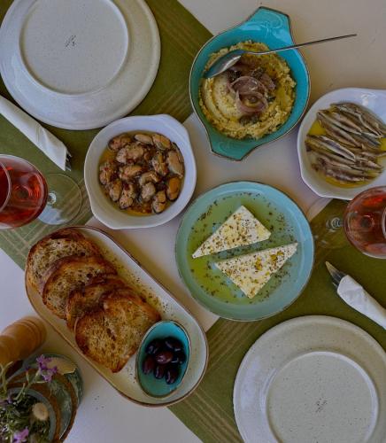 a table with plates of food on a table at Akrotiri B&B in Pórto Káyio