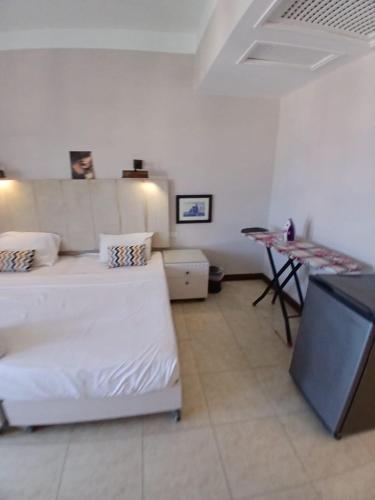 a bedroom with a bed and a table in a room at Studio in gouna with beach access - Economy stay in Hurghada