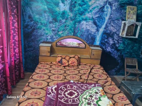 a bedroom with a bed in front of a mural at Himalayan homestay opposite to white waterinn hotel, Tipa Road, mecleodganjj in Dharamshala