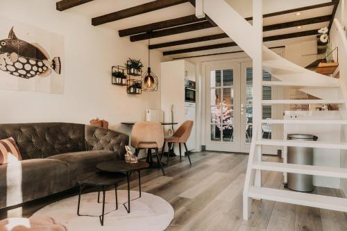 a living room with a couch and a table at Vakantiehuisje Dichtbij Zee in Vlissingen