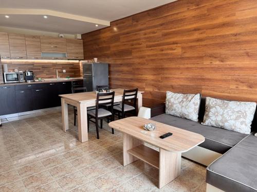 a living room with a couch and a table at Sea View 1 Bedroom Apartment - Pool & Free Parking - Kavarna in Kavarna