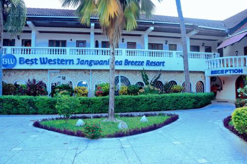 a building with a sign that reads best western javan beach resort at Best Western Jangwani Sea Breeze Resort in Dar es Salaam