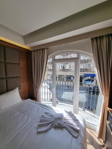a bedroom with a bed with a bow tie on it at RIJJI HOTEL ISTANBUL OLD CiTY in Istanbul