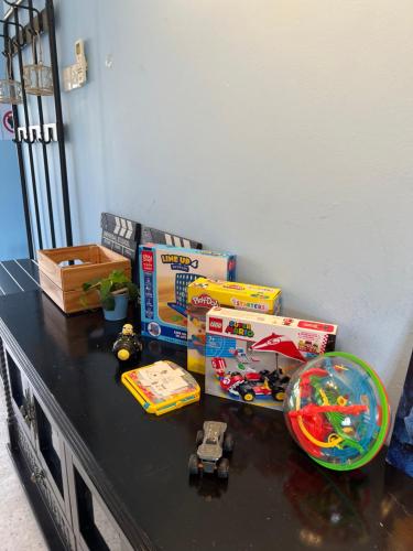 a table with toys and boxes on top of it at Minions In The Hills in Bentong