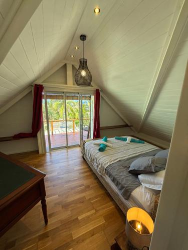 a bedroom with a bed in the attic at Villa Pétrel in Saint-Paul