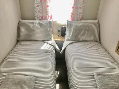 two beds sitting next to each other in a room at Debran Lodge in Angus
