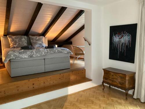 a bedroom with a bed and a wooden ceiling at Großzügige individuelle Wohnung am Starnberger See in Münsing am Starnberger See