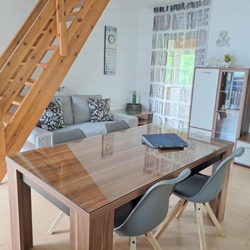 a dining room with a wooden table and chairs at Apartments Rupnik in Bovec