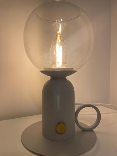 a glass lamp sitting on top of a table at UMA Home in Rome