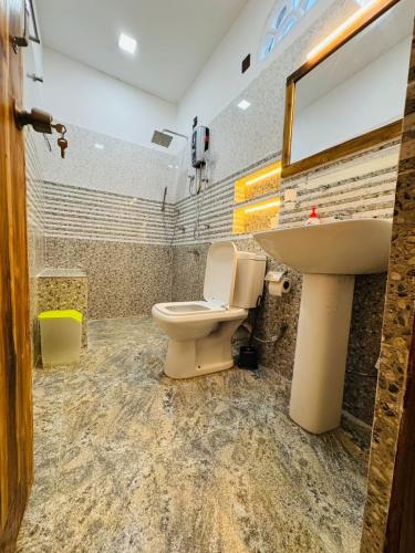 a bathroom with a toilet and a sink at Arugam Bay Holiday in Arugam Bay