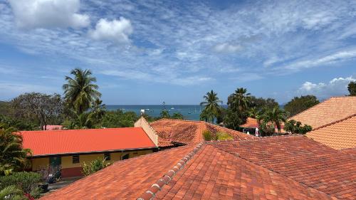 a group of roofs with the ocean in the background at #Vacances en #Martinique in Sainte-Anne