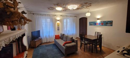 a living room with a couch and a dining room table at DeTillierStudiò2 in Aosta