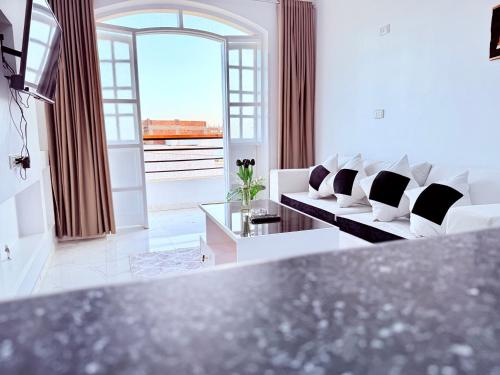 a living room with white furniture and a large window at White Gorf Hotel in Luxor