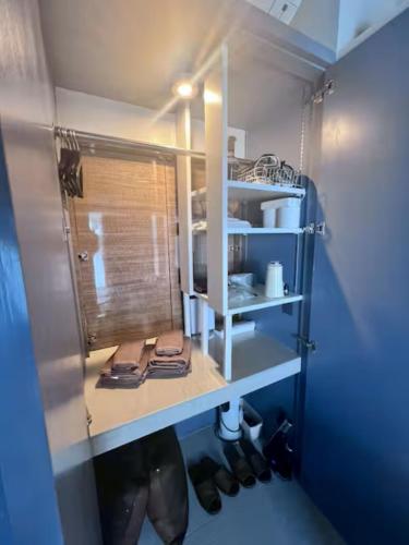 a room with a shelf with shoes and a window at HOTEL Viviana in Naha