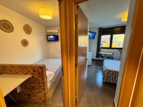 a small room with two beds and a hallway at MT Boutique Suites y Apartamentos - Adults Only - in Mataró