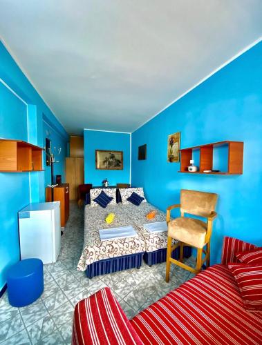 a blue room with a bed and a chair at Villa Đuričić 200m od mora in Đenovići