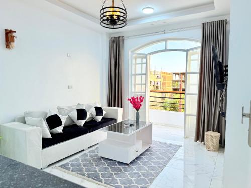 a white living room with a couch and a table at White Gorf Hotel in Luxor