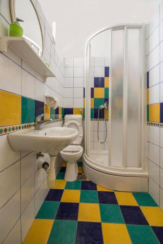 a bathroom with a sink toilet and a shower at Ground floor apartment in Razvala