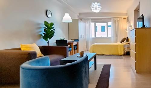 a living room with a couch and a bed at Charming Modern Condo in BGC in Manila