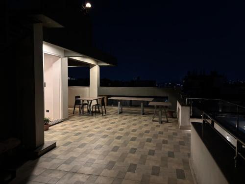 a rooftop patio with tables and chairs at night at Lavish Stay at Boudha, Kathmandu, Heuju Residence in Kathmandu