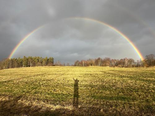 a rainbow over a field with a fence in a field at Chalupy Albrechtice Šumava in Sušice