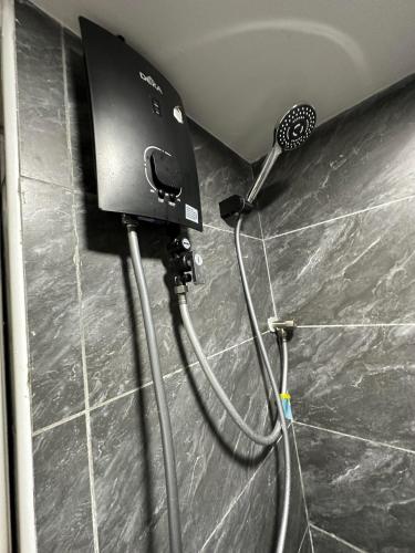 a hair dryer is attached to a wall at SS Grey House Bukit Bintang in Kuala Lumpur