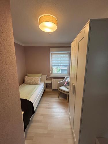 a small bedroom with a bed and a window at "Haus Bella" in Cochem