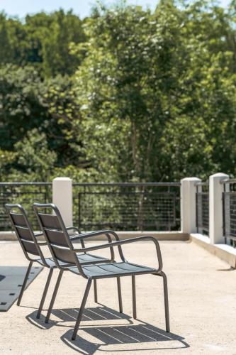 two chairs sitting next to each other on a patio at La Coudraie - Proche de Disneyland in Montévrain