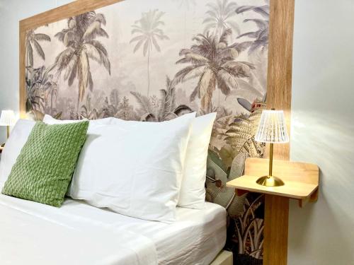 a bedroom with a bed with a palm tree wallpaper at Secret Palm in Koh Phangan