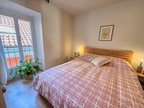 a bedroom with a large bed and a window at Alla Torre - Città Vecchia Locarno in Locarno