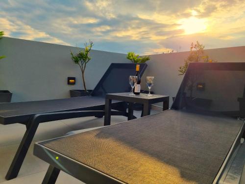 a balcony with two tables and two wine glasses at 10 Apartments & Suites Athens in Athens
