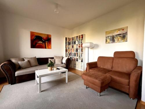 a living room with a couch and a table at Chez Chantal - Zwischen Alltag & Auszeit in Halle an der Saale