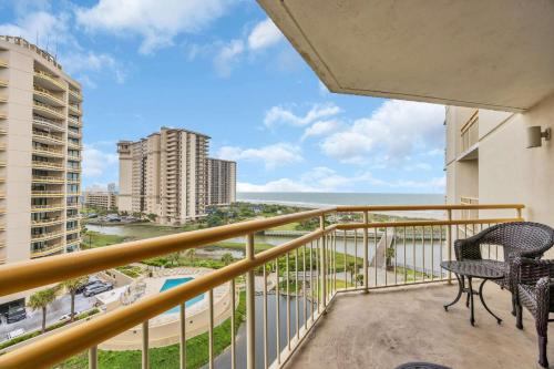 a balcony with chairs and a view of the ocean at Oceanfront Condo Huge Pools Top Rated Ocean Creek Resort in Myrtle Beach