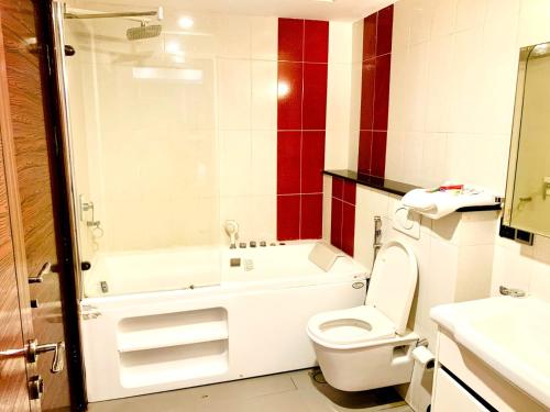 a bathroom with a toilet and a shower and a sink at One Bedroom apartment Centaurus Islamabad in Islamabad