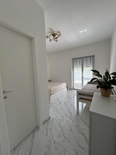 a large white room with a bed and a table at Villa Grazia in SantʼAgata di Militello