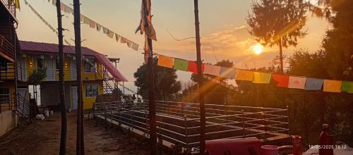 a fence with prayer flags in front of a building at Everest Home Stay Temal Kalimati Tower in Thapathali