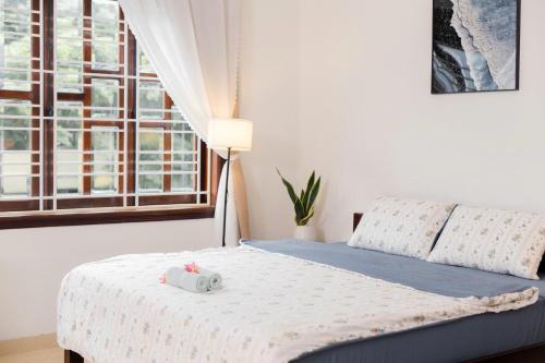 a bed with two hello kitty pillows on it in a bedroom at Green homestay, Huế in Hue